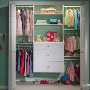 A Young Girls Closet With Frequently Used Items On The Bottom Shelves And Drawers
