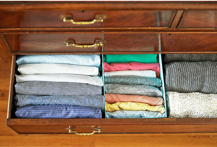 folded clothes standing up in a drawer for increased closet storage 