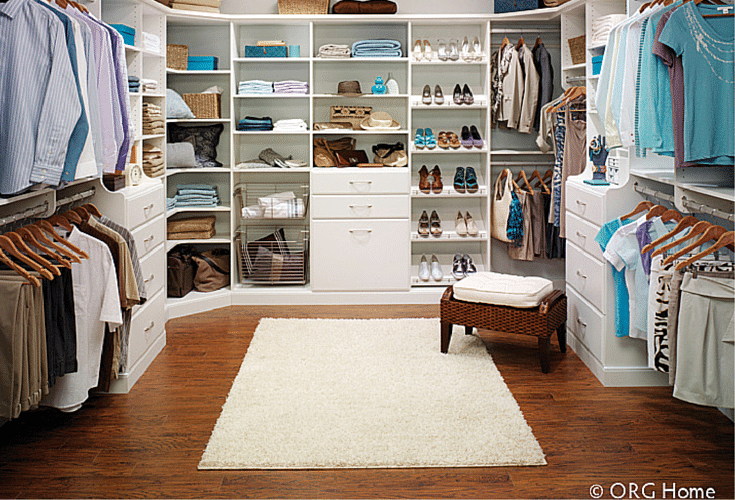 a visual divide between his and hers closet areas in a walk in closet columbus
