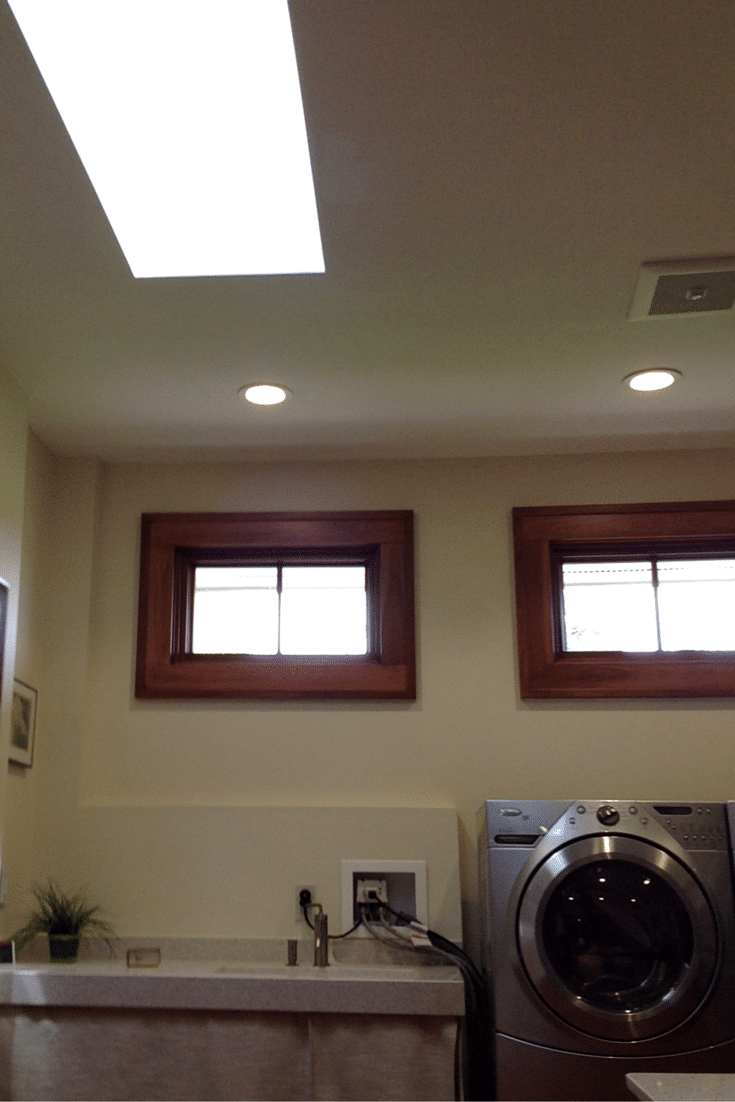 Natural lighting using transom windows and an operable skylight in a universal design custom closet 