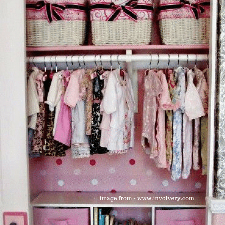 This girl's reach in closet added a fun touch with a wallpaper added to the back wall. 