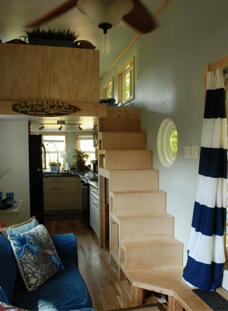 storage compartments under the stairs in a luxury tiny home 