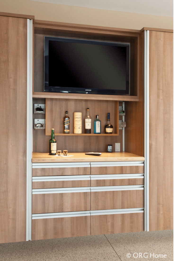 Entertainment zone in garage wood cabinets in Columbus Ohio man cave | Innovate Home Org