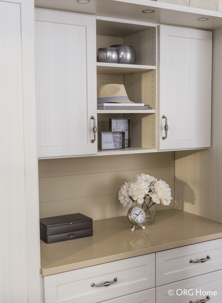 A custom bedroom closet design with drawers and a display countertop | Innovate Home Org Columbus Ohio
