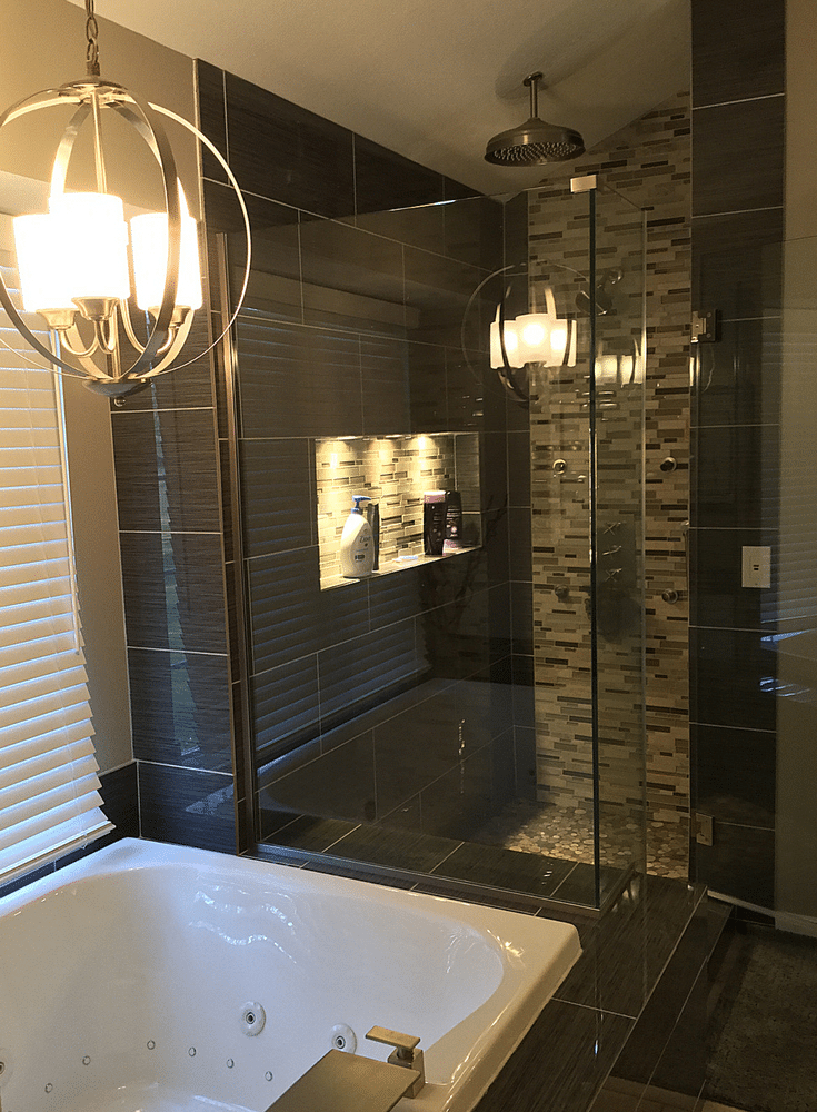 A contemporary bathroom remodel in Upper Arlington Ohio with large format tiles and a chandelier | Innovate Building Solutions and Innovate Home Org Columbus Ohio 