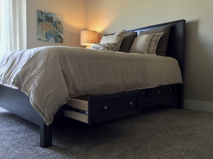 A guest bedroom in an empty nester designed home with extra storage under the bed - Innovate Home Org Columbus Ohio
