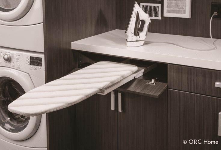 Fold out ironing board in a custom laundry room storage project - Innovate Home Org Columbus Ohio 