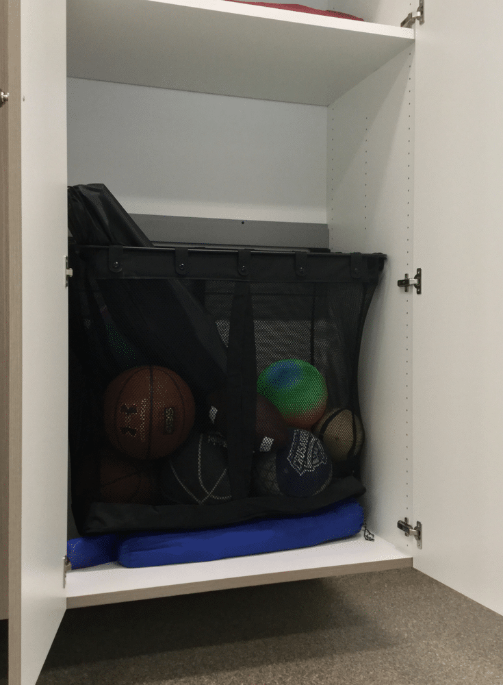 Large mesh garage sport storage basket inside custom cabinetry | Innovate Home Org Columbus Ohio