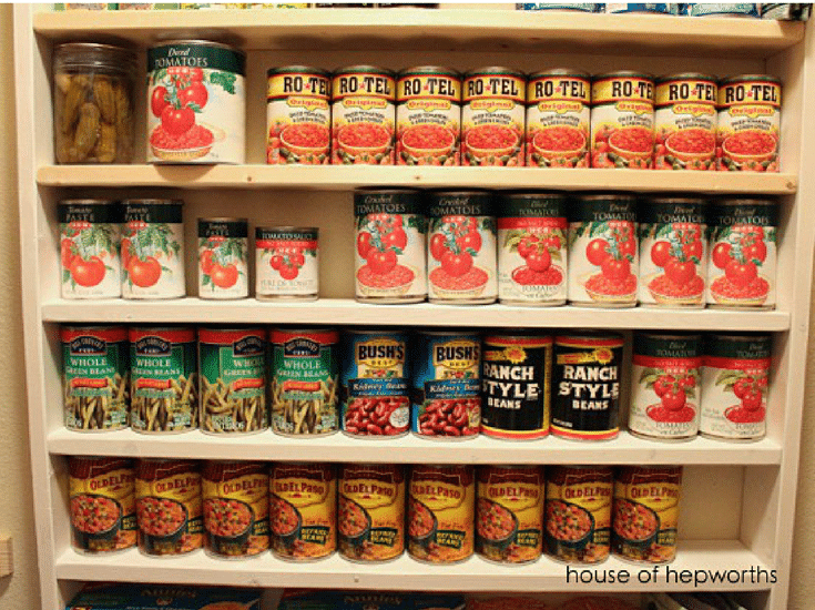 Canned goods on shelves in an organized pantry