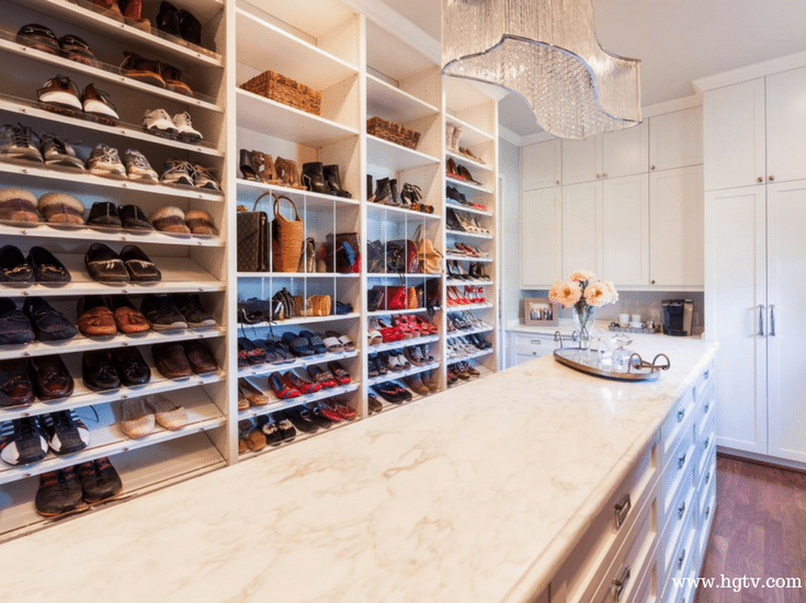 Angled and raised shoe shelves in a luxury custom closet | Innovate Home Org Columbus Ohio 