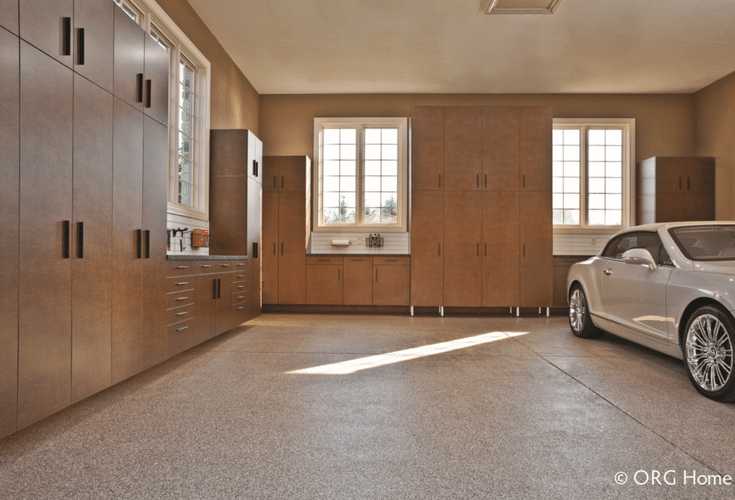 Concealed garage cabinets doors and a workbench for a clean efficient luxury garage storage area | Innovate Home Org Columbus Ohio