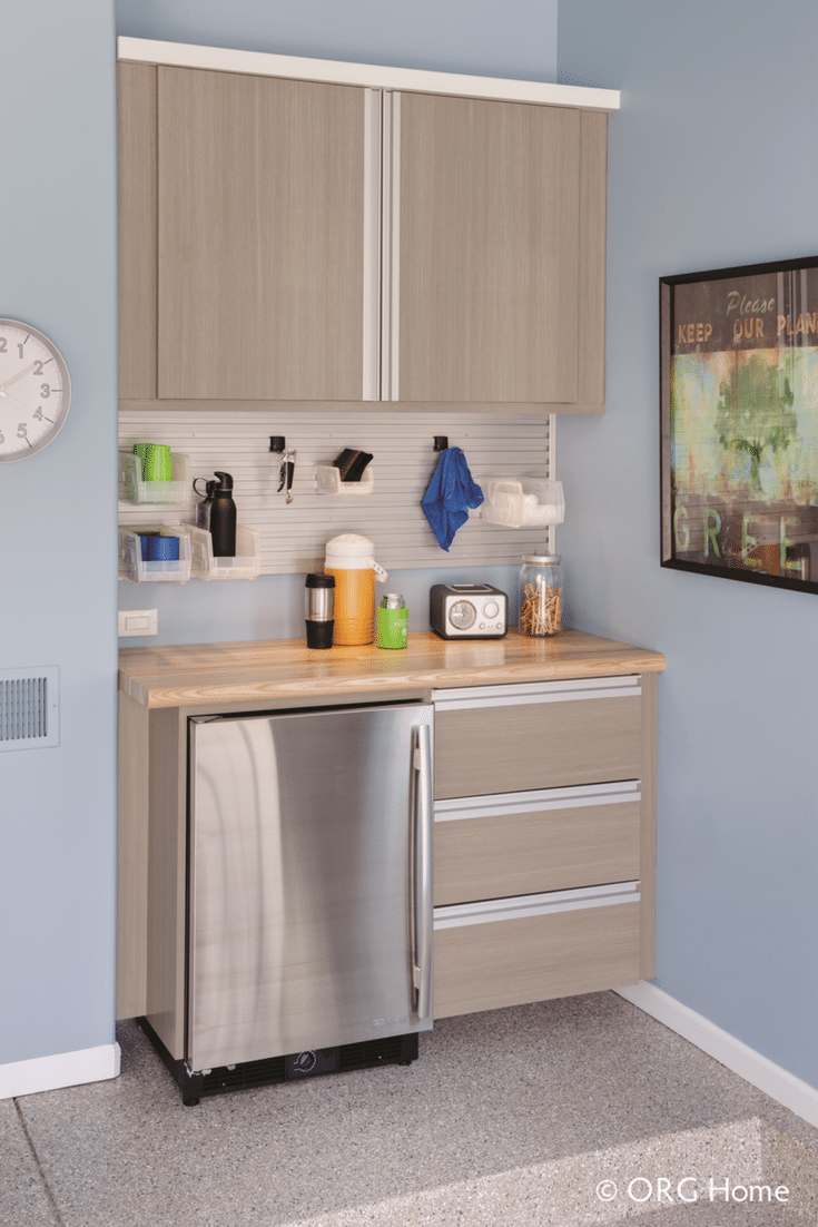 Garage organization workbench with a butcher block top and wall mounted upper cabinets | Innovate Home Org Columbus Ohio 