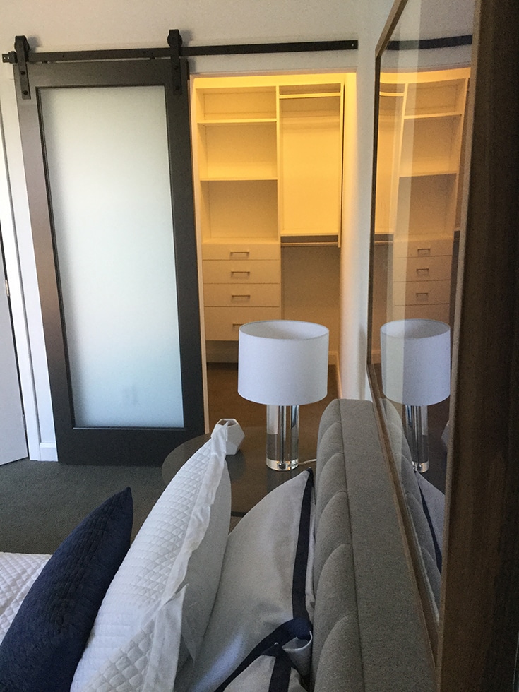 White laminate wall hung closet with double hanging section in a loft in columbus | Innovate Home Org | Columbus Closets | #CustomStorage #Columbustorage #DoubleHungStorage 