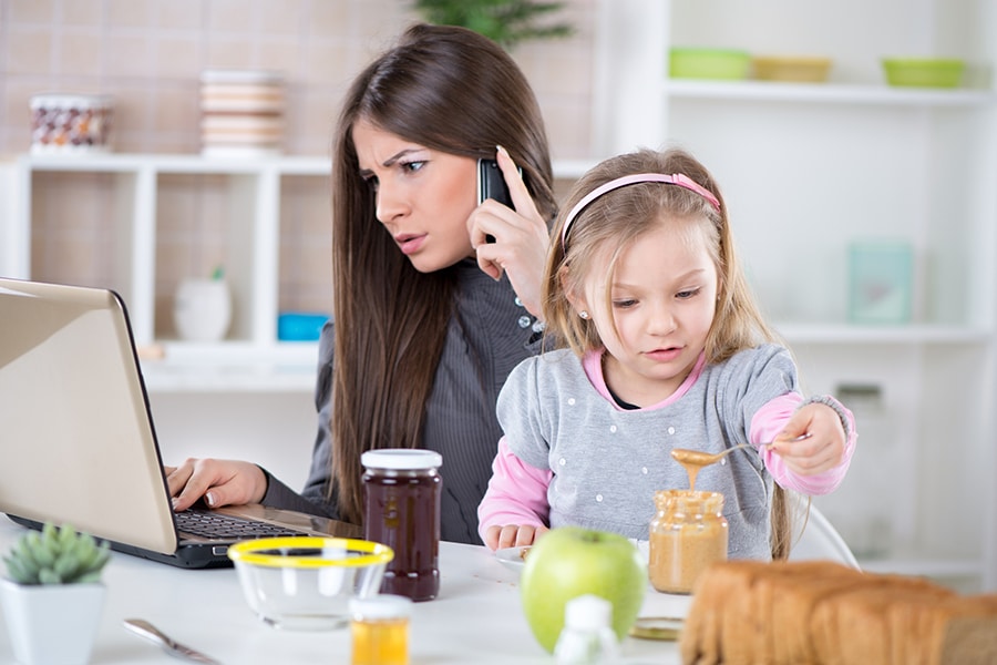 Frustrated mom work at home kid interrupting at kitchen table | Innovate Building Solutions | Innovate Home Org | #WorkFromHome #OfficeSpace #Working #HomeOffice