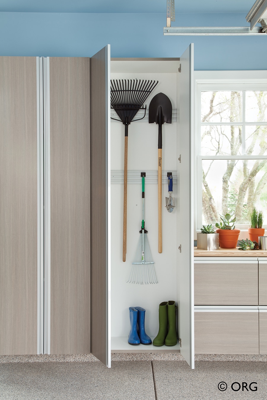 Factor 10 slatwall and hooks in a cabinet with shovels and rakes Columbus ohio | innovate Home Org #slatwall #Garagehooks #Storagehooks #cabinetstorage